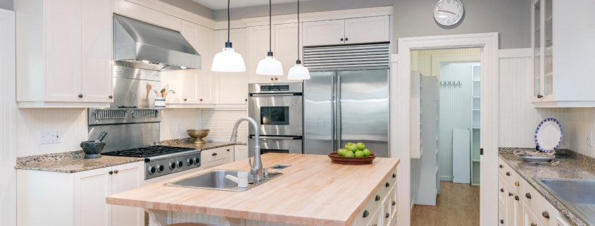 Amazing Luxury Kitchen Interior in white with wooden floor and kitchen island.